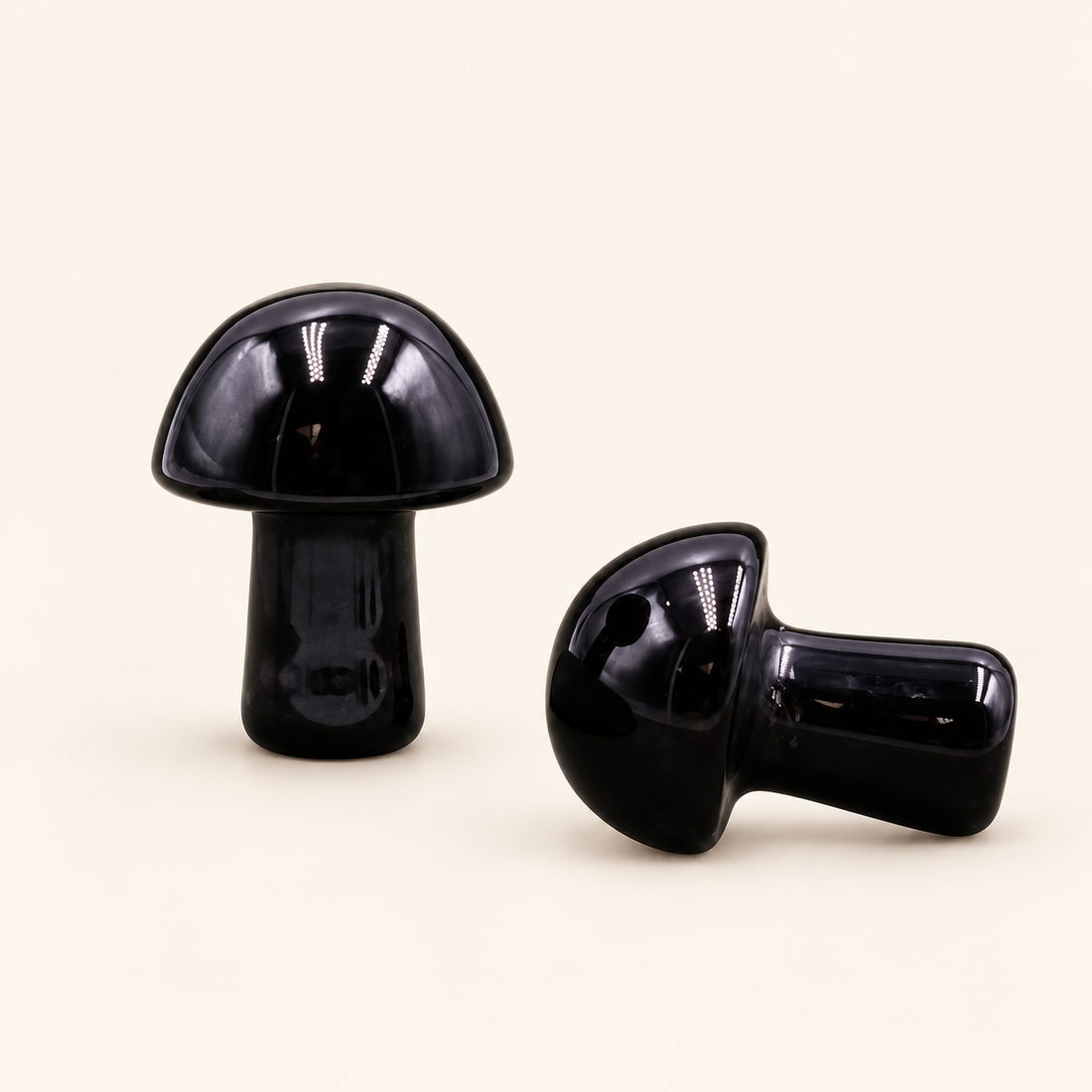 Black Obsidian Carved Mushroom with deep black shine on a soft ivory background