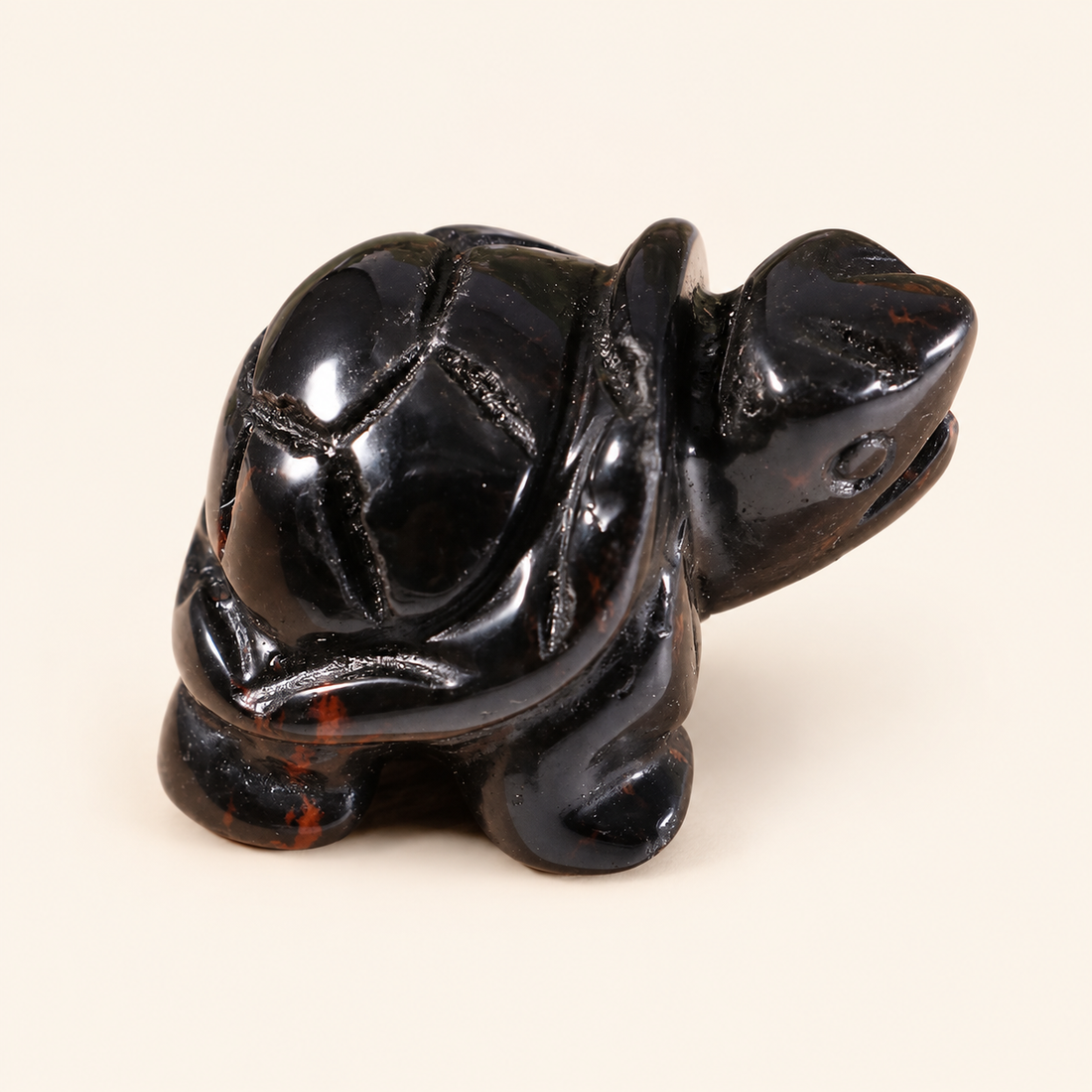 Black Onyx Carved Turtle with deep black color on a soft ivory background