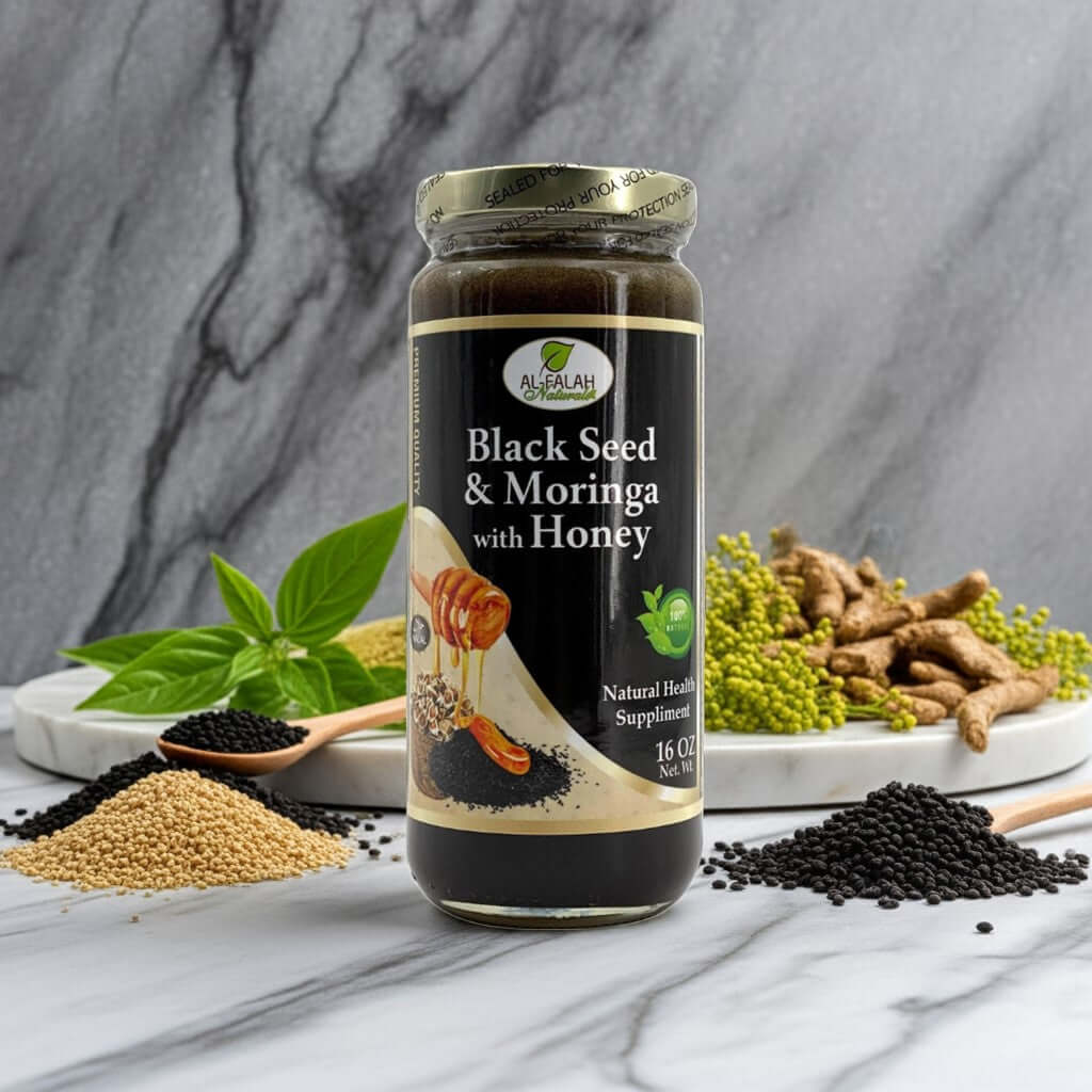 Jar of Black Seed & Moringa Herbal Honey with herbs on a white marble counter.