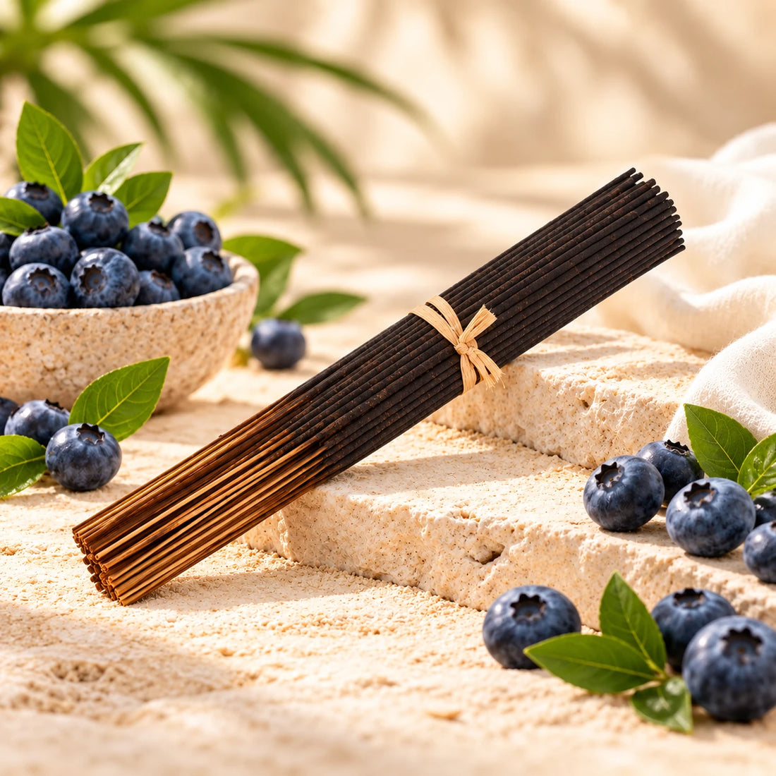Blueberry incense sticks surrounded by blueberries.