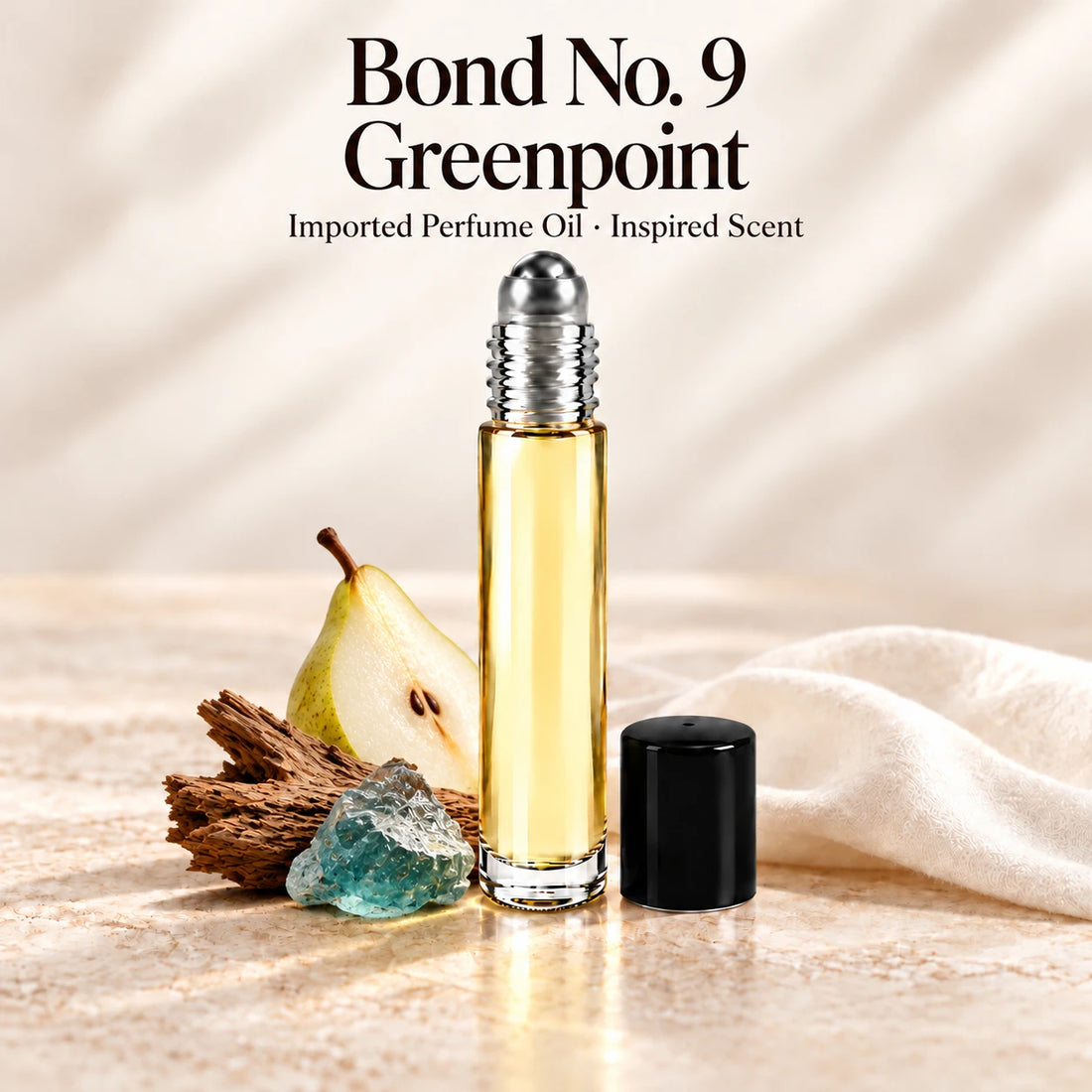 Bond No. 9 Greenpoint Perfume Oil in a slim glass roll-on bottle with a silver roller and black cap on an ivory stone surface.