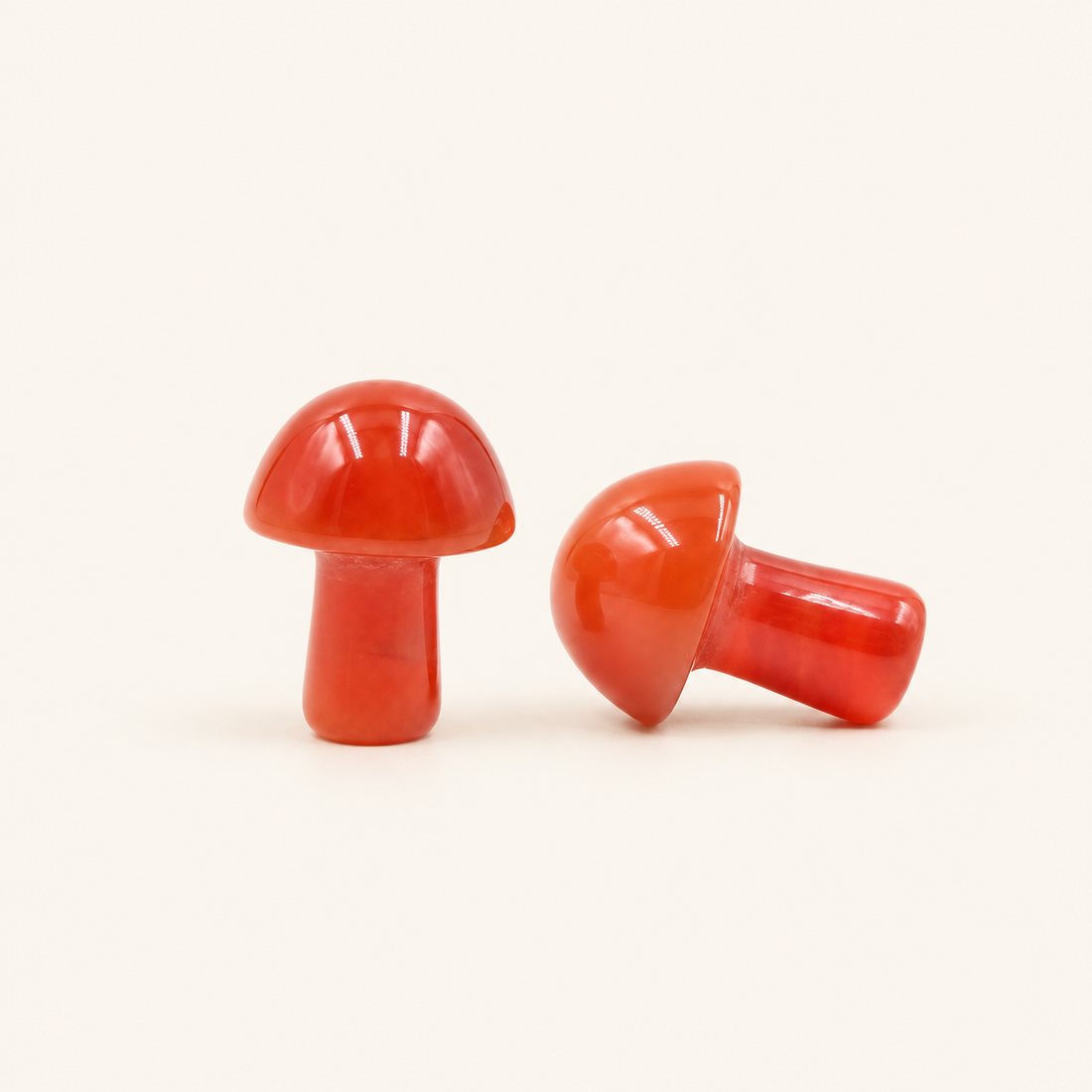 Carnelian Carved Mushroom with warm orange-red tones on a soft ivory background