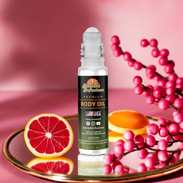 Bath & Body Works Champagne Toast Inspired Body Oil with citrus and berries on a pink background