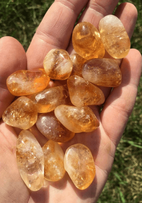 Natural Citrine tumbled stones ideal for new moon rituals, highlighting their abundance-attracting energy.