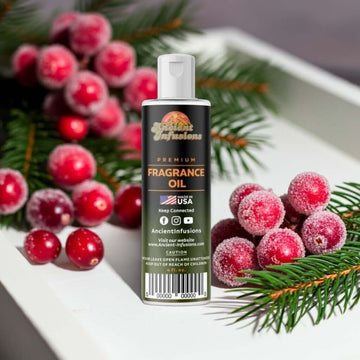 Bottle of Cranberry Fragrance Oil with fresh cranberries and pine branches