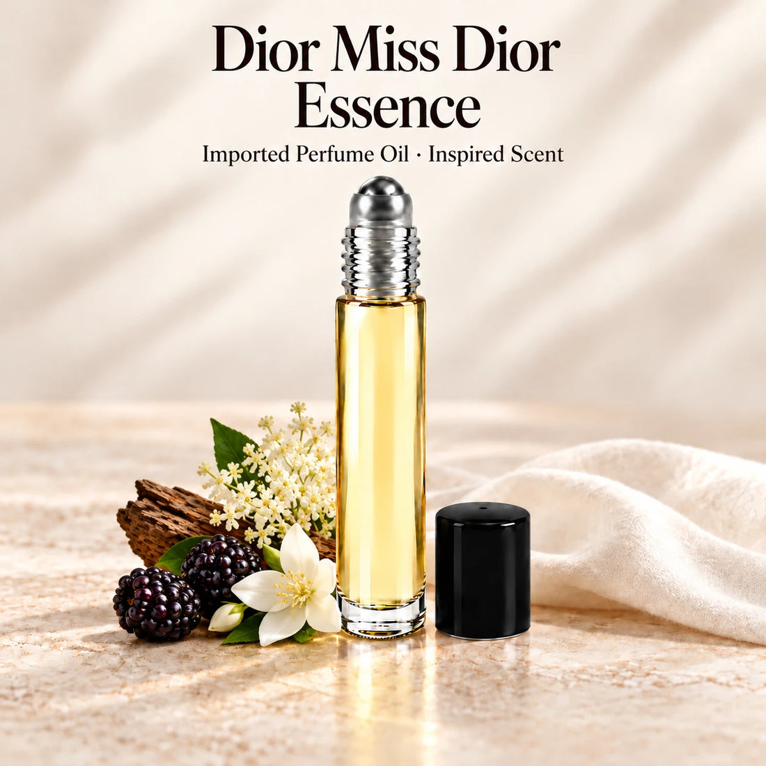 Dior Miss Dior Essence Perfume Oil in a slim glass roll-on bottle with a silver roller and black cap on an ivory stone surface.