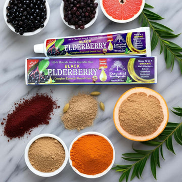 Essential Palace Elderberry 5-in-1 Fluoride-Free Toothpaste with elderberries, babool, grapefruit, and cardamom on marble counter