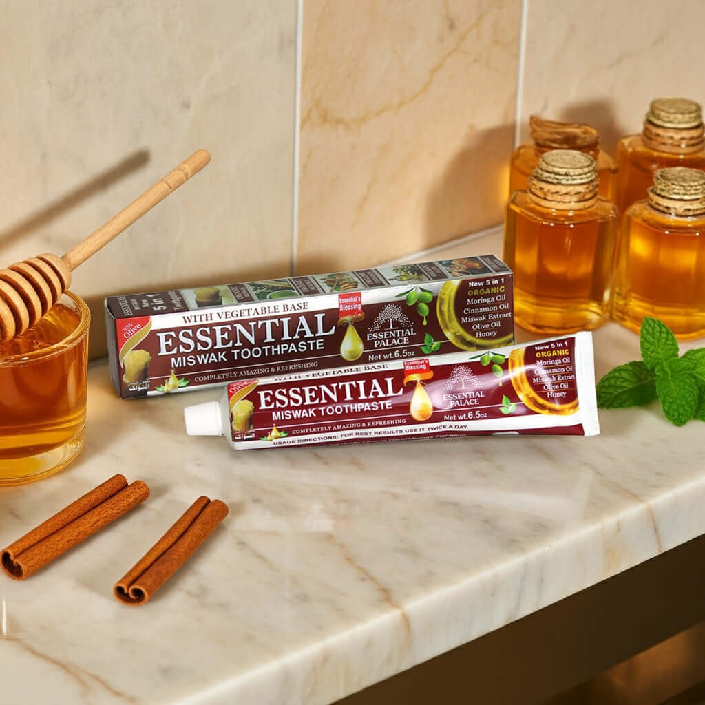 Essential Palace Miswak 5-in-1 Fluoride-Free Toothpaste with natural ingredients on marble counter with honey and cinnamon display
