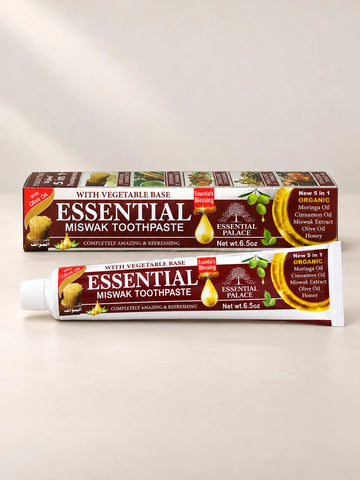 Essential Palace Miswak Toothpaste 5-in-1 fluoride-free toothpaste tube and box on a pale warm greige background.