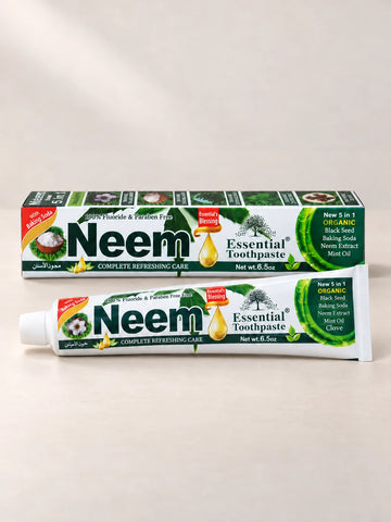 Essential Palace Neem Toothpaste 5-in-1 fluoride-free toothpaste tube and box on a pale warm greige background.