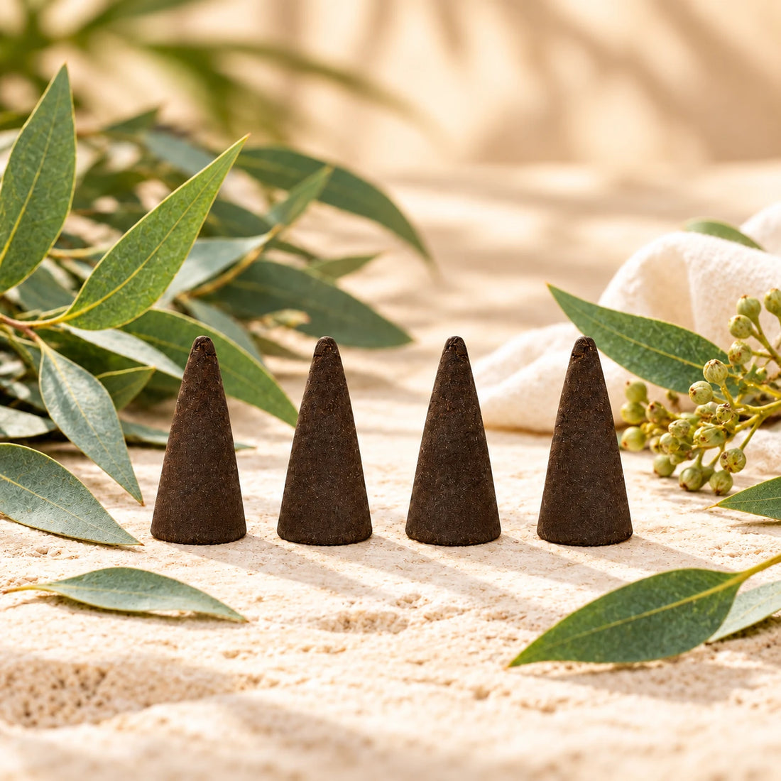 Eucalyptus Incense Cones on cream stone.