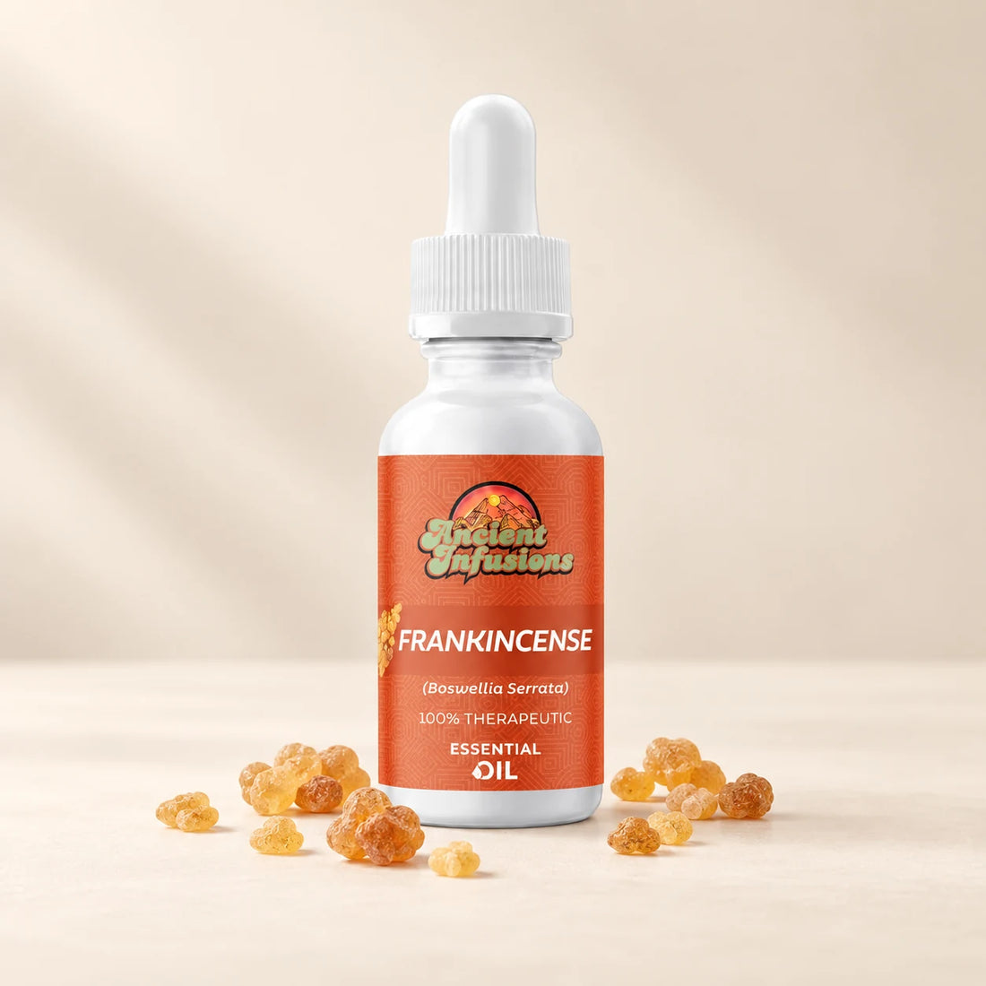 Ancient Infusions Frankincense Essential Oil bottle with botanicals on a soft ivory background.