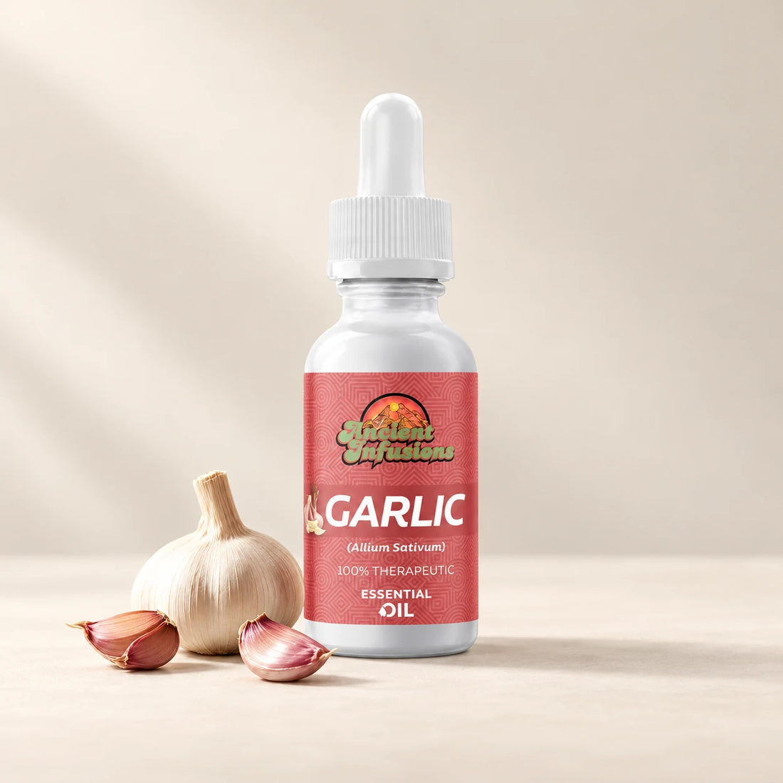 Ancient Infusions Garlic Essential Oil bottle with botanicals on a soft ivory background.