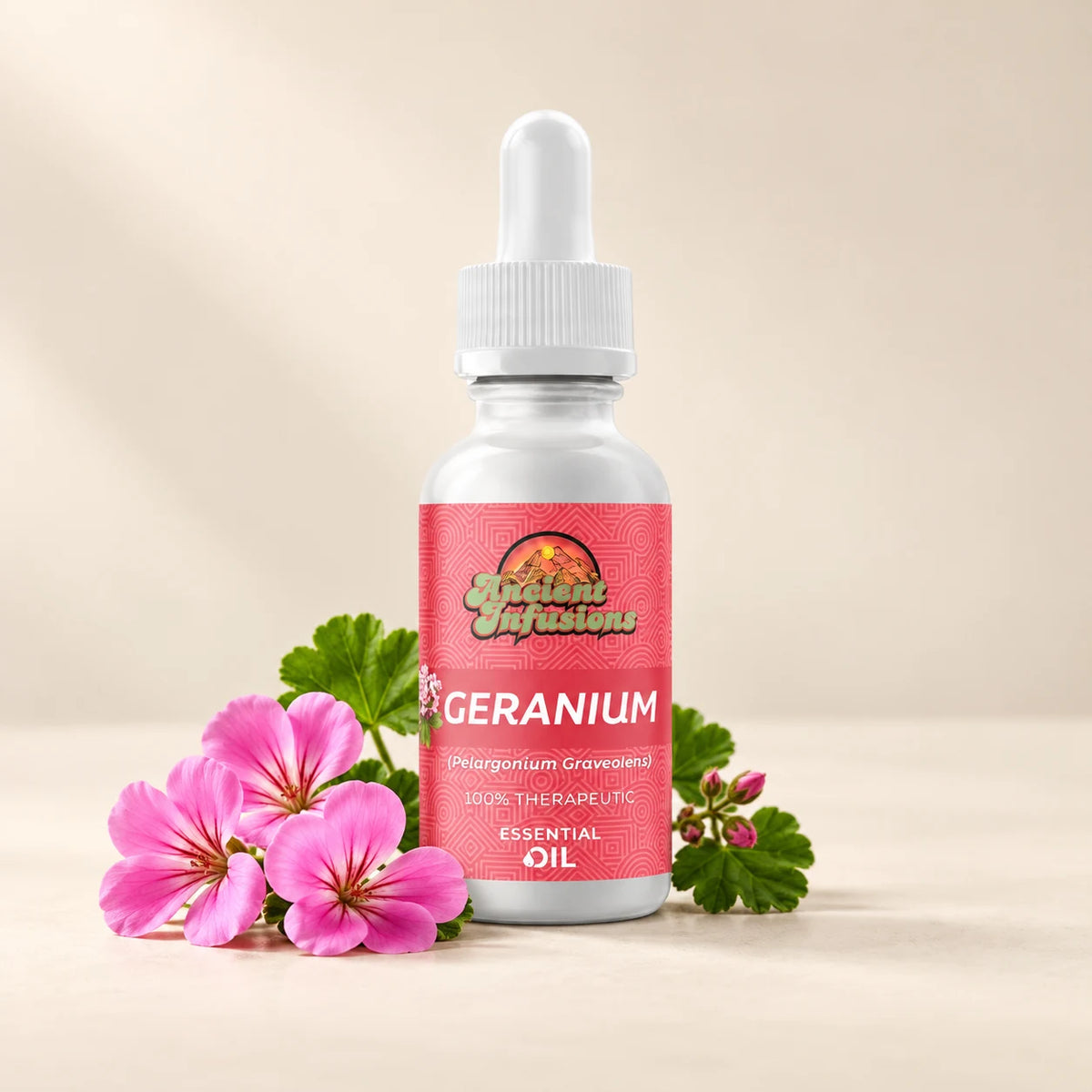 Ancient Infusions Geranium Essential Oil bottle with botanicals on a soft ivory background.