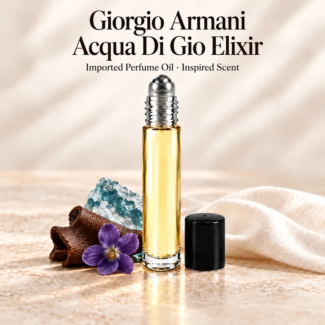Giorgio Armani Acqua Di Gio Elixir Perfume Oil in a slim glass roll-on bottle with a silver roller and black cap on an ivory stone surface.