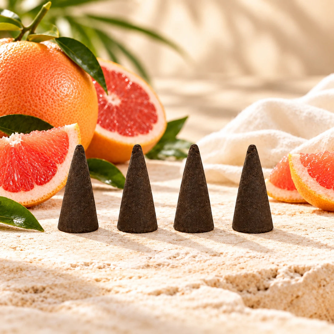 Grapefruit Incense Cones on cream stone.