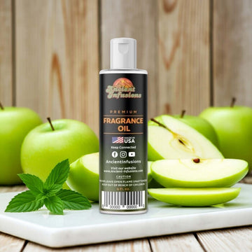 Bottle of Green Apple Fragrance Oil with fresh apples in the background, conveying a crisp, tart, and refreshing scent.