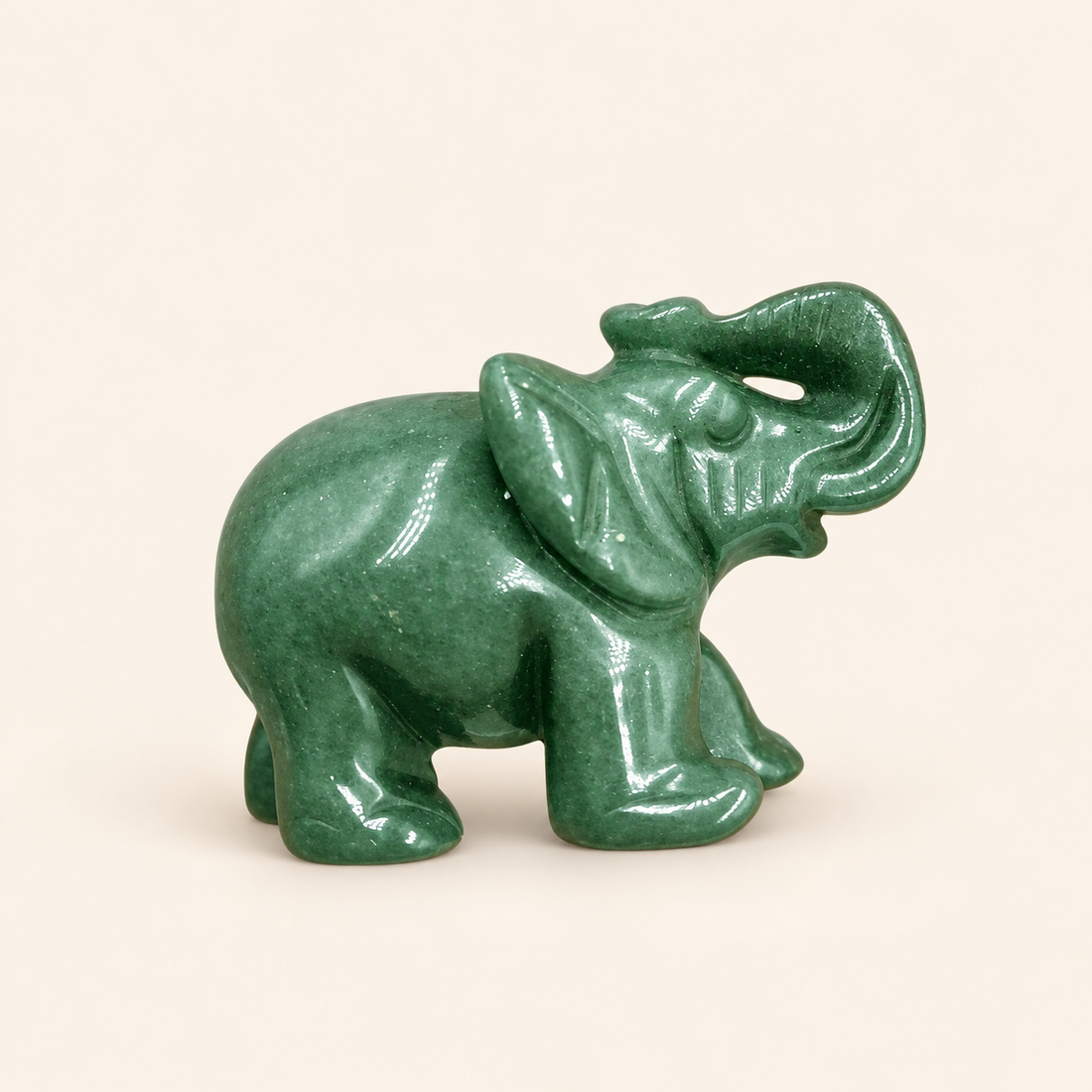 Green Aventurine Carved Elephant with soft green tones on a soft ivory background