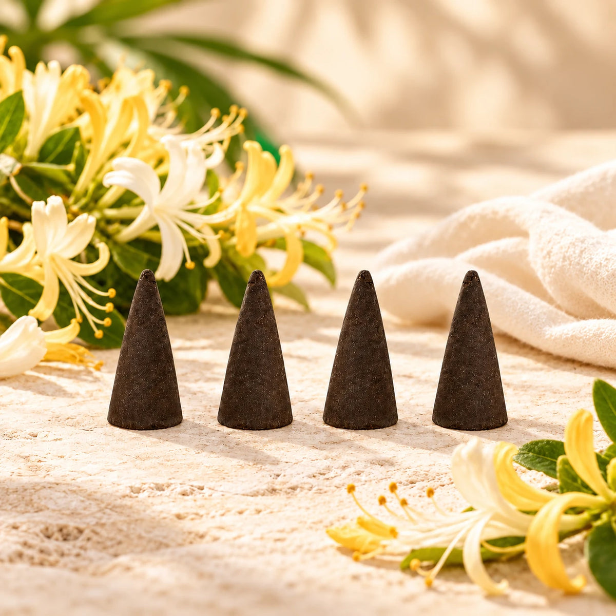 Honeysuckle Incense Cones on cream stone.