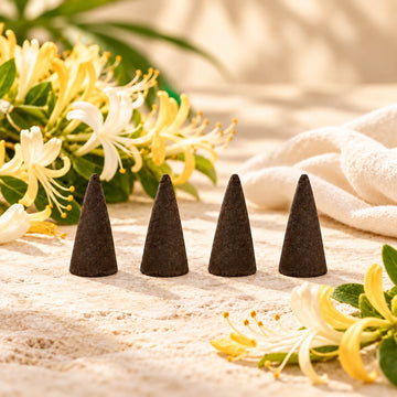 Honeysuckle Incense Cones on cream stone.