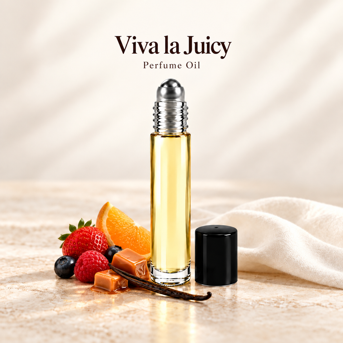 Juicy Couture Viva la Juicy Perfume Oil with simple scent note accents on soft ivory