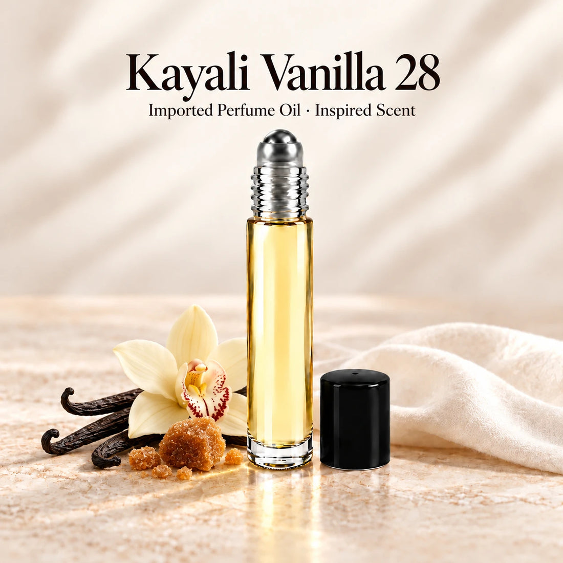Kayali Vanilla 28 Perfume Oil in a slim glass roll-on bottle with a silver roller and black cap on an ivory stone surface.