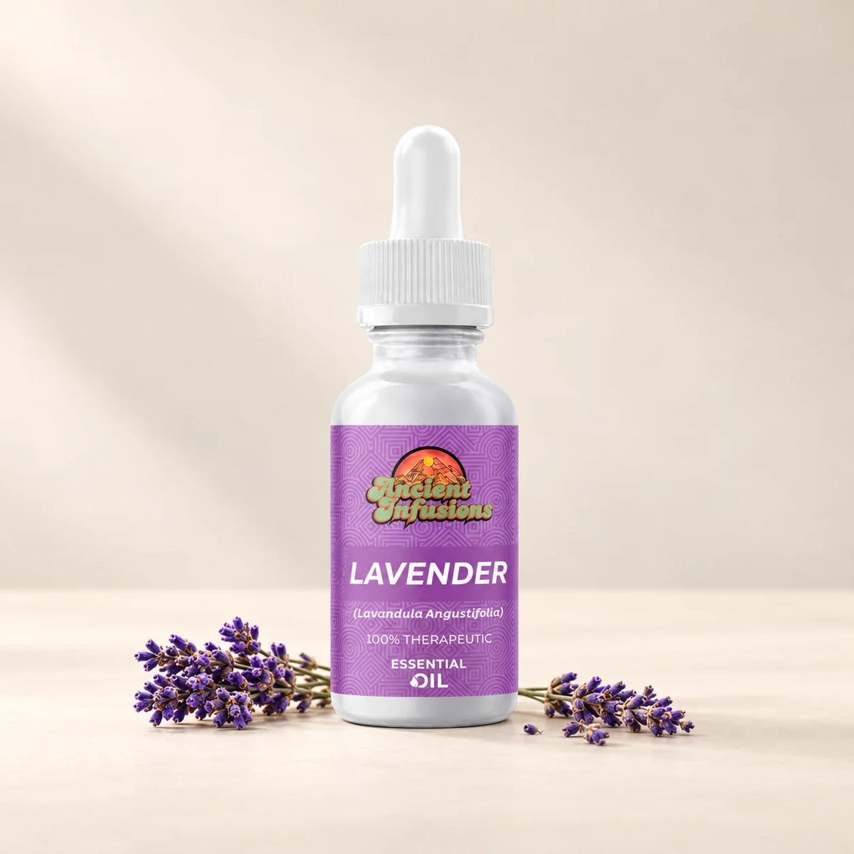 Ancient Infusions Lavender Essential Oil bottle with botanicals on a soft ivory background.