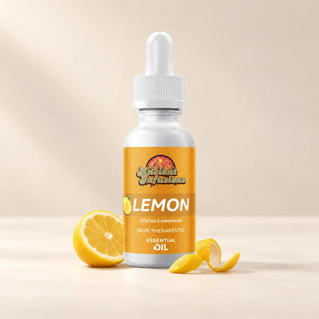Ancient Infusions Lemon Essential Oil bottle with botanicals on a soft ivory background.