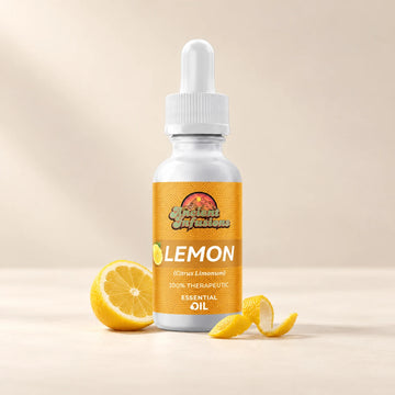 Ancient Infusions Lemon Essential Oil bottle with botanicals on a soft ivory background.