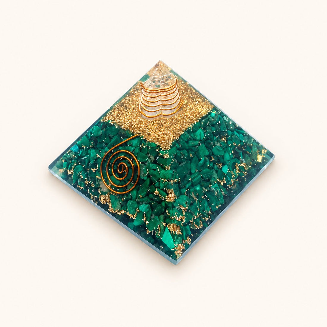 Malachite Orgone Pyramid with rich green malachite chips and metallic details on a warm ivory background