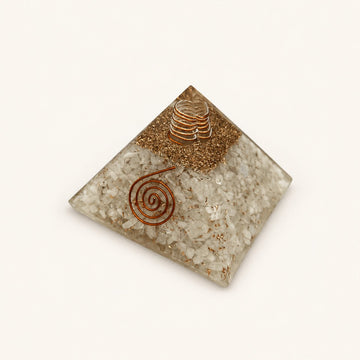 Moonstone Orgone Pyramid with soft ivory moonstone chips and metallic details on a warm ivory background