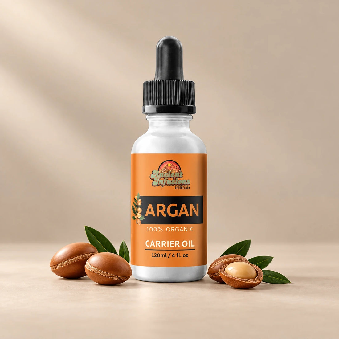Ancient Infusions Moroccan Argan Carrier Oil silver bottle with black dropper on a warm stone background.