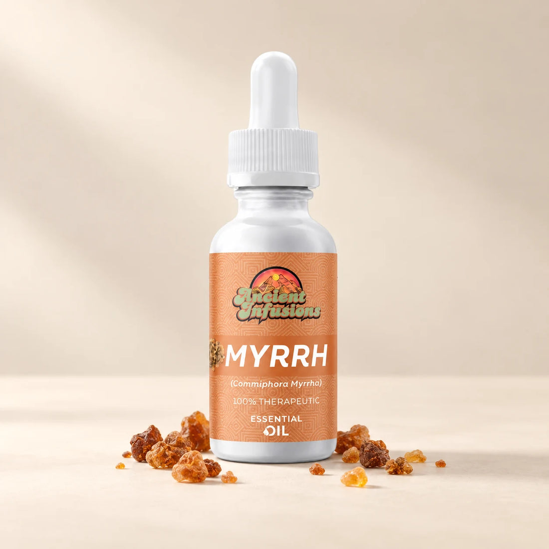 Ancient Infusions Myrrh Essential Oil bottle with botanicals on a soft ivory background.