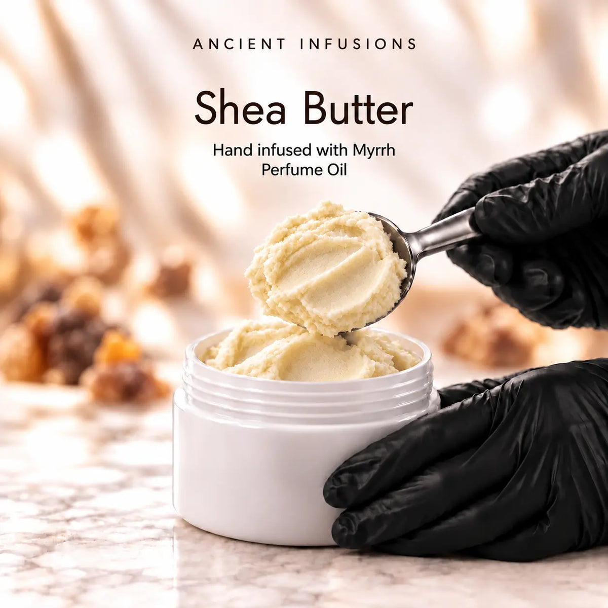 Black vinyl-gloved hands scoop raw shea butter hand infused with Myrrh perfume oil.
