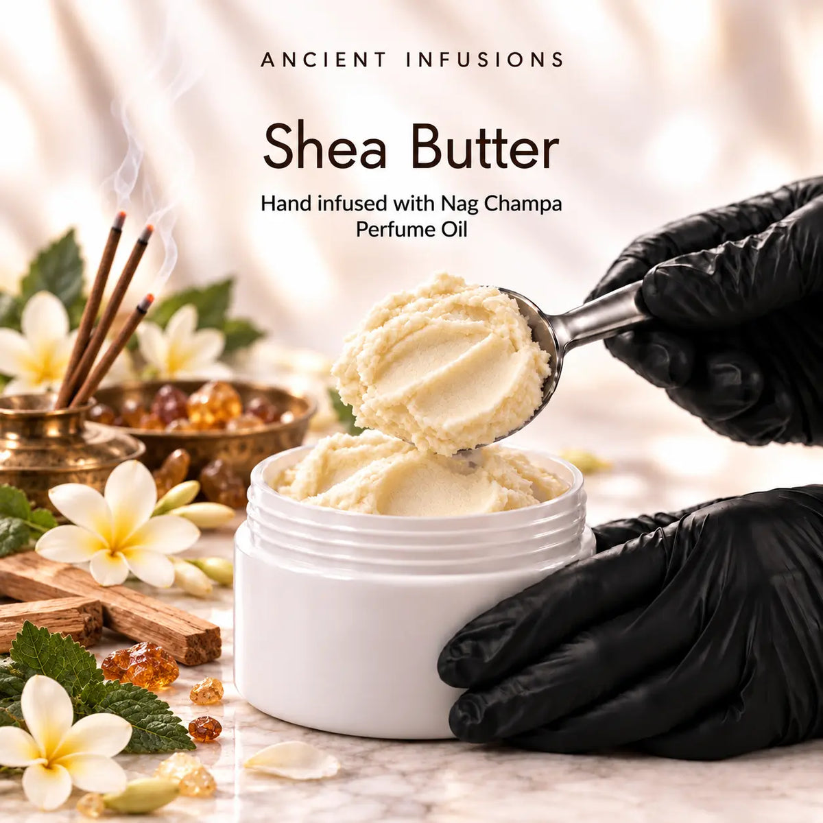Black vinyl-gloved hands scoop raw shea butter hand infused with Nag Champa perfume oil.