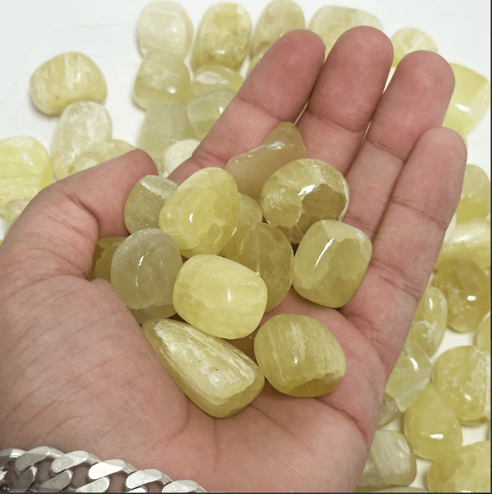 Genuine lemon quartz tumbled stones showcasing their bright yellow hues and unique textures, ideal for healing and emotional clarity.