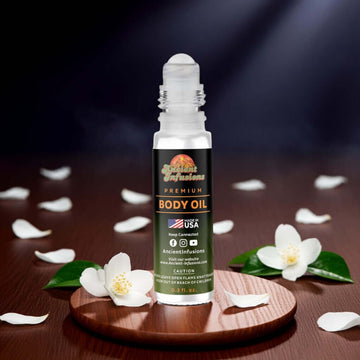 Night Queen body oil standing upright on a wooden platform with florals and soft lighting