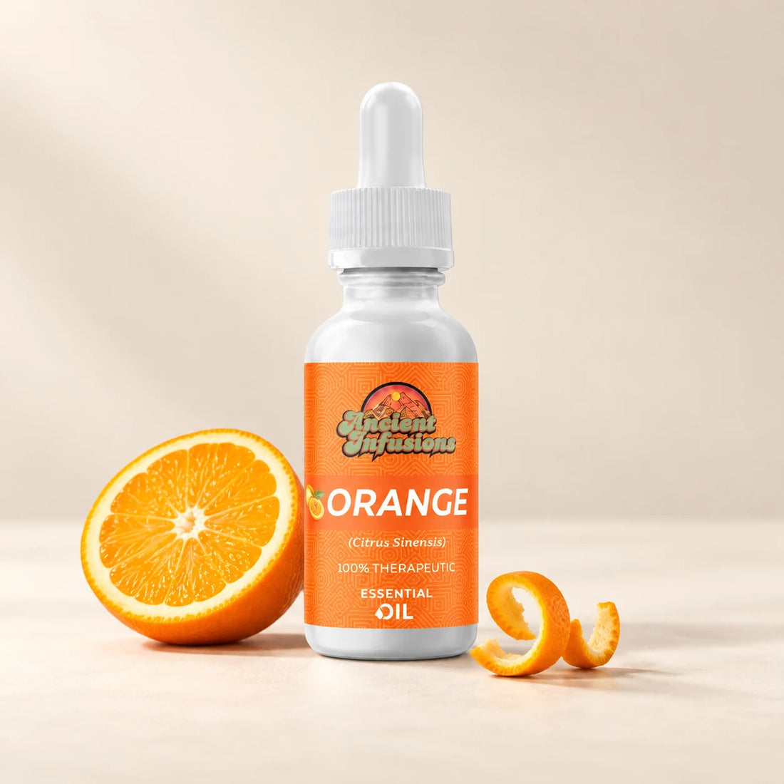 Ancient Infusions Orange Essential Oil bottle with botanicals on a soft ivory background.