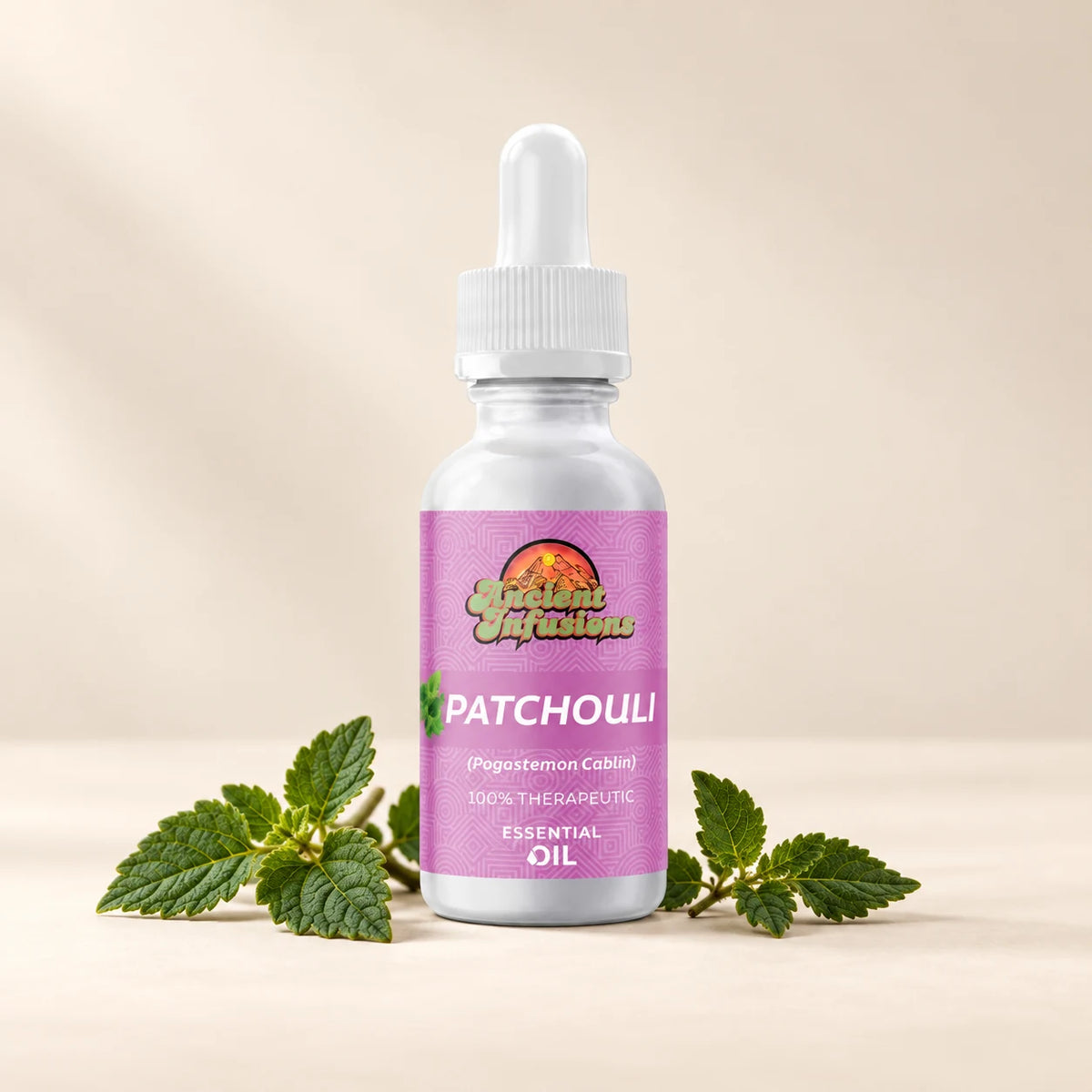 Ancient Infusions Patchouli Essential Oil bottle with botanicals on a soft ivory background.
