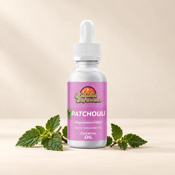 Ancient Infusions Patchouli Essential Oil bottle with botanicals on a soft ivory background.