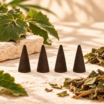 Patchouli Incense Cones on cream stone.
