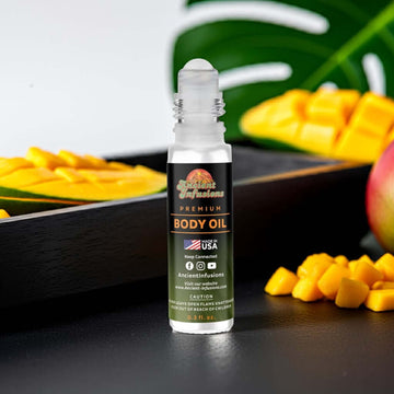 Polo Black Inspired Body Oil bottle with sliced mango in background emphasizing fresh scent, alcohol-free fragrance oil.