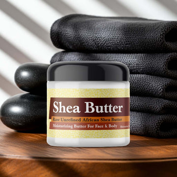 Mugler A Man Inspired Scented Shea Butter jar on a wooden table with towels and spa stones.