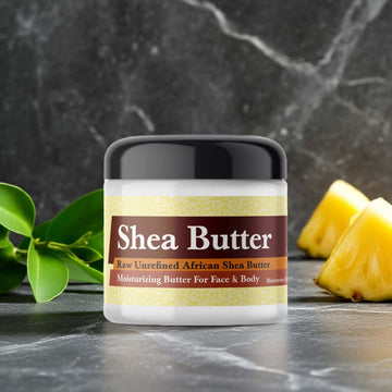 Creed Aventus Inspired Scented Shea Butter, organic African shea butter jar on marble surface with pineapple and leaves