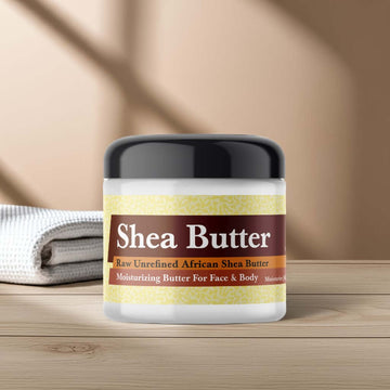 Fresh Linen Scented Shea Butter in jar on wooden table, perfect for moisturizing face and body, with soft towel background.