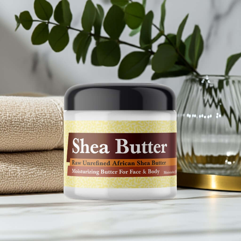 Michelle Obama Inspired Scented Shea Butter jar on a marble surface with green leaves and towels in the background.