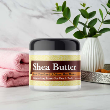 Paris Hilton Rose Rush Inspired Scented Shea Butter jar on marble surface with towels and plant