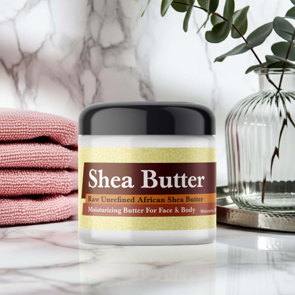 Wet Kisses Scented Shea Butter jar on marble surface with pink towels and plant.