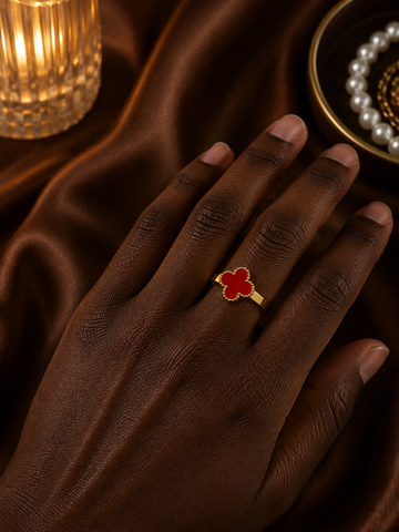 Red clover gold-tone ring worn on hand with an elegant polished finish.