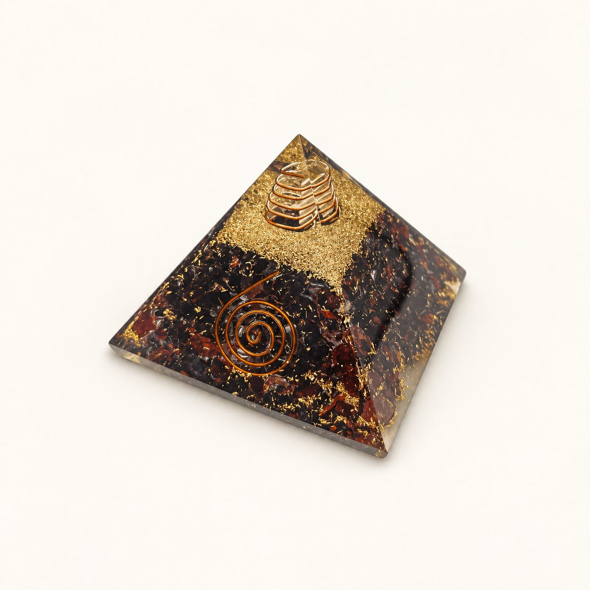 Red Garnet Orgone Pyramid with deep wine-red garnet chips and metallic details on a warm ivory background